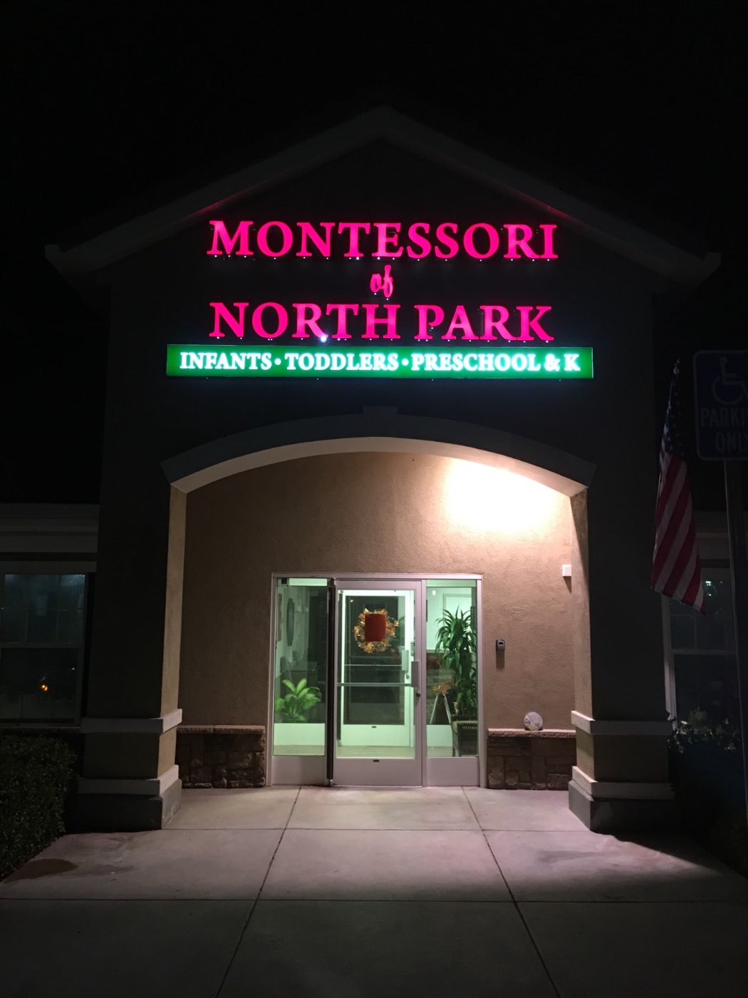 Illuminated Montessori sign at night